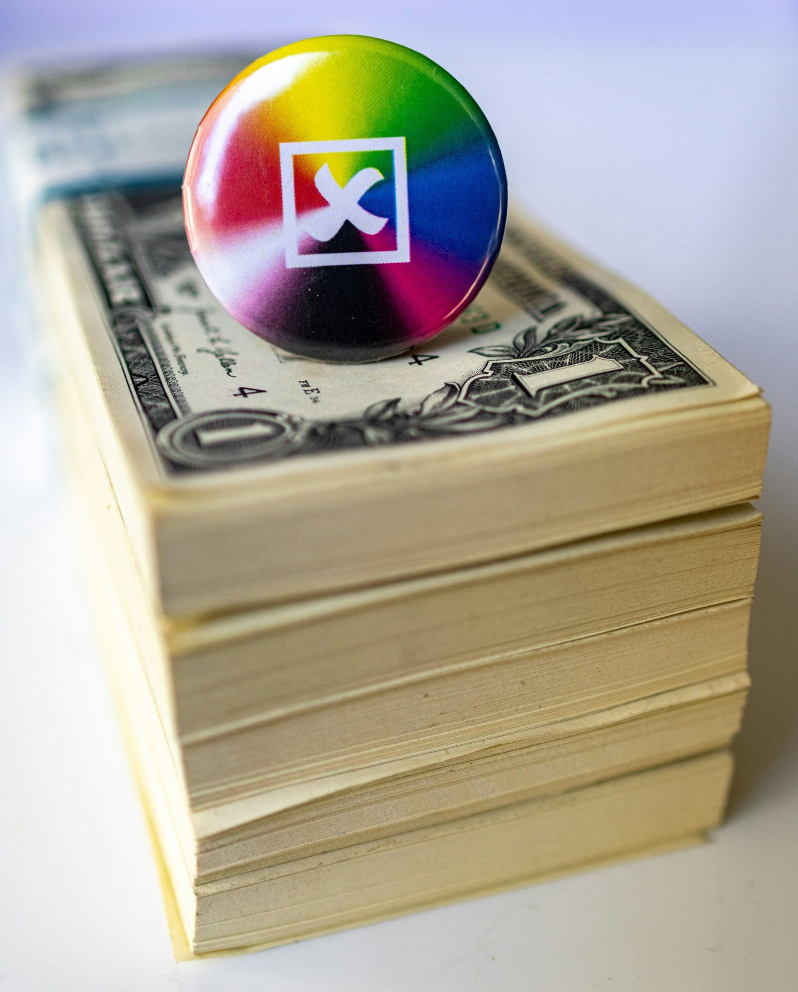 A button sitting on top of a stack of money